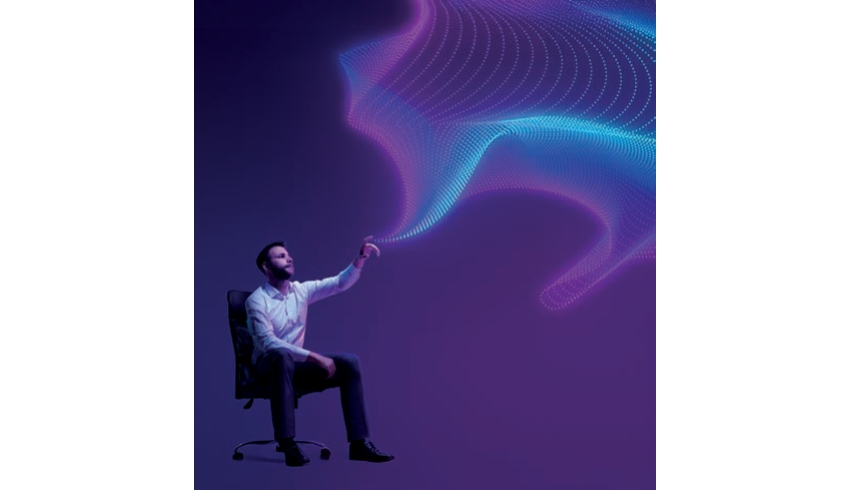 A man sitting on a chair against a purple background